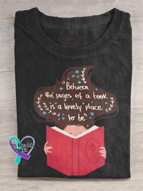 ’Between The Pages Of A Book Is Lovely Place To Be’ Lover Graphic Printed T-Shirt Black / S