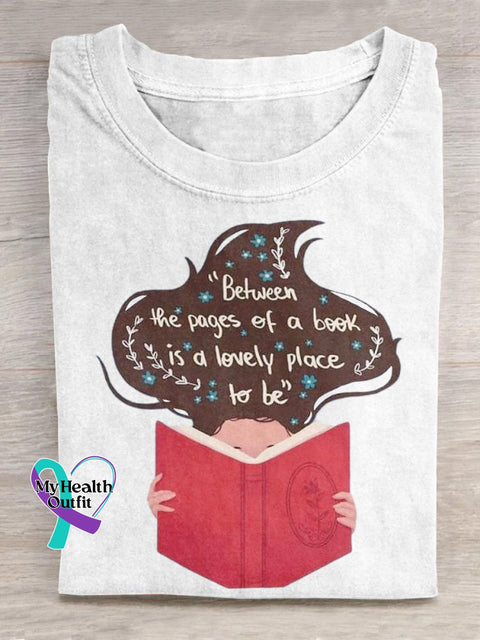 ’Between The Pages Of A Book Is Lovely Place To Be’ Lover Graphic Printed T-Shirt White / S