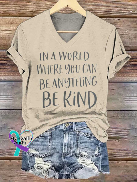 Women’s IN A WORLD WHERE YOU CAN BE ANYTHING BE KIND V-neck Casual T-Shirt Sand / S